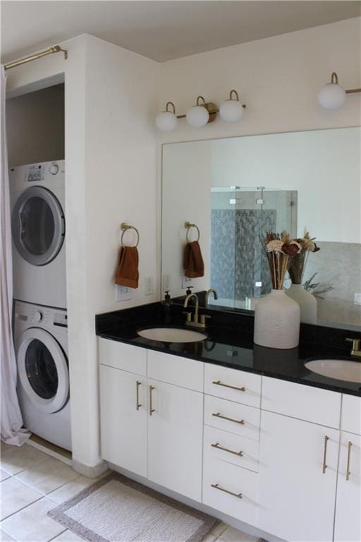 711 Cosmopolitan Dr Unit 413, Atlanta, GA 30324 - bathroom with stacked washing machine and dryer, double vanity, tiled shower, and tile patterned flooring