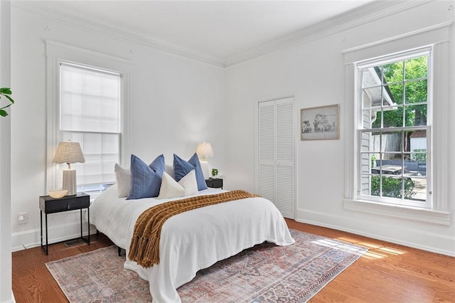 343 Josephine St NE, Atlanta, GA 30307 - bedroom with wood finished floors, multiple windows, ornamental molding, and a closet