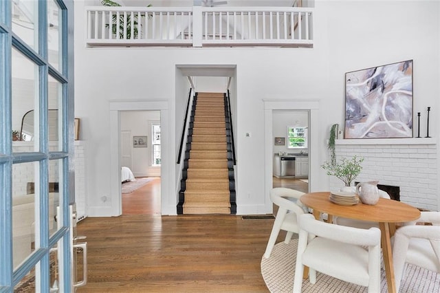 343 Josephine St NE, Atlanta, GA 30307 - dining room with a high ceiling, wood finished floors, stairs, and a fireplace