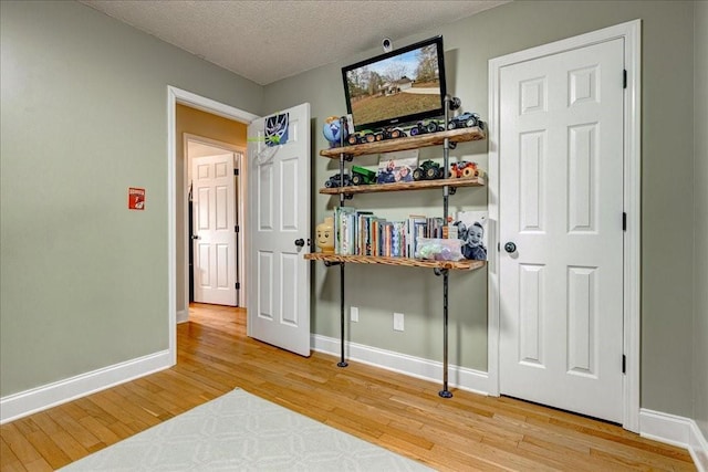 interior space with hardwood / wood-style flooring and a textured ceiling