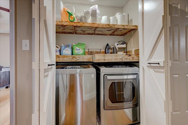 clothes washing area featuring independent washer and dryer