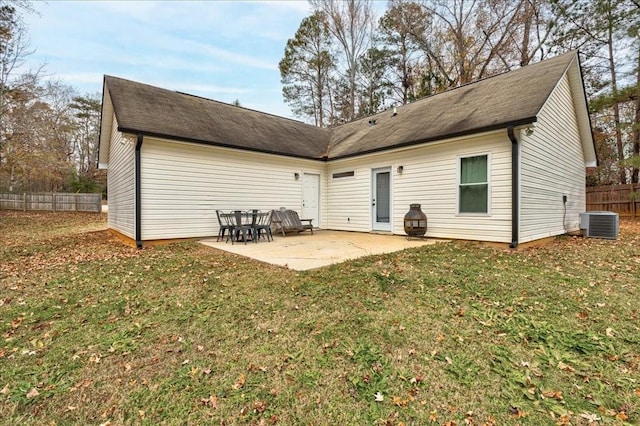 rear view of house with a lawn, a patio, and central air condition unit