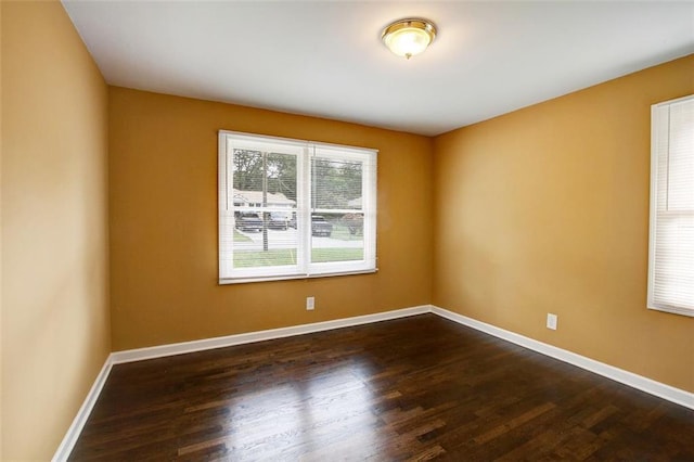 empty room featuring dark hardwood / wood-style flooring