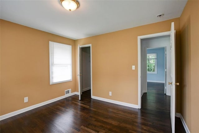 spare room with dark hardwood / wood-style floors