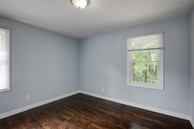 unfurnished room with dark hardwood / wood-style floors