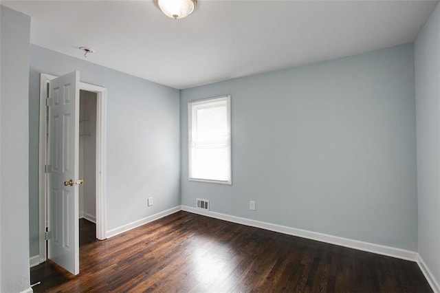 empty room featuring dark wood-type flooring