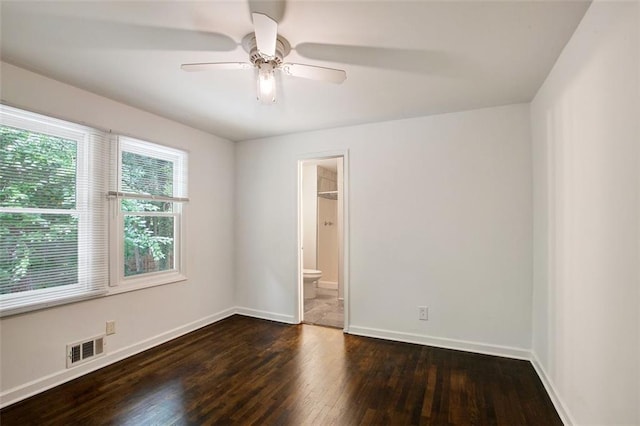 unfurnished room featuring ceiling fan and dark wood-type flooring