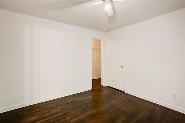 empty room with dark hardwood / wood-style floors and ceiling fan