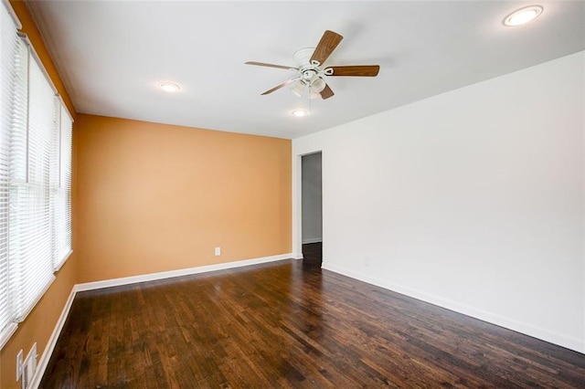 spare room with dark hardwood / wood-style floors and ceiling fan