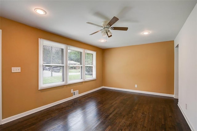 empty room with dark hardwood / wood-style floors and ceiling fan