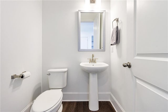 bathroom with hardwood / wood-style floors and toilet