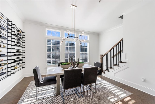 dining space with a notable chandelier, dark hardwood / wood-style flooring, crown molding, and a wealth of natural light