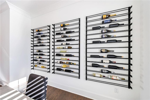 wine room featuring dark hardwood / wood-style flooring and ornamental molding