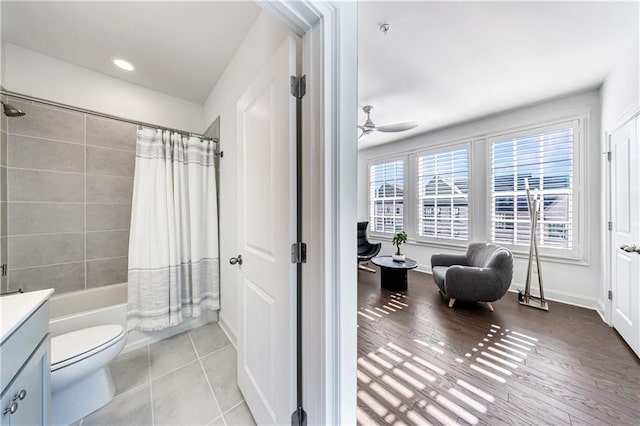 full bathroom featuring shower / bath combo, vanity, ceiling fan, hardwood / wood-style floors, and toilet