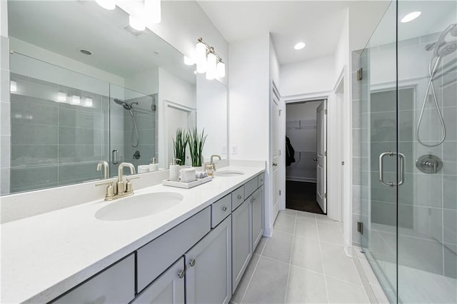 bathroom featuring tile patterned flooring, vanity, and an enclosed shower