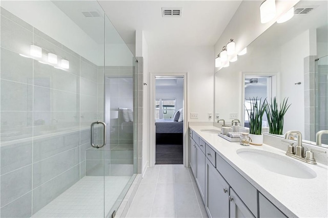 bathroom featuring tile patterned flooring, vanity, and walk in shower