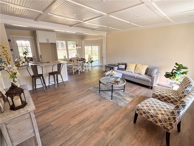 living room with coffered ceiling and dark wood-type flooring