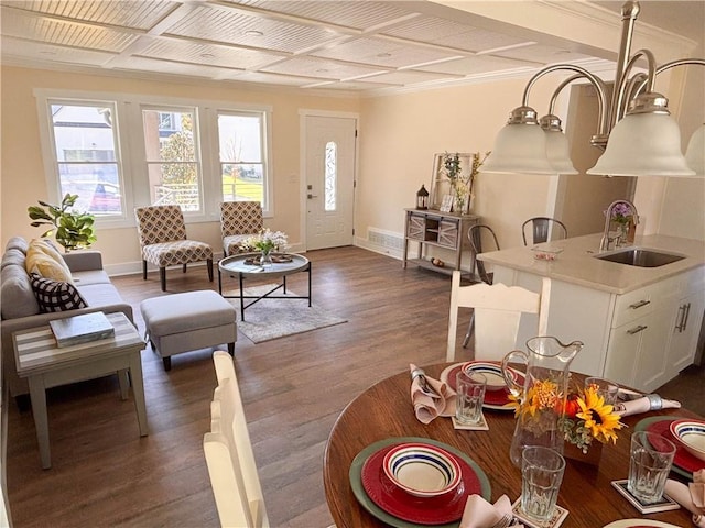 living room with coffered ceiling, sink, and dark hardwood / wood-style floors