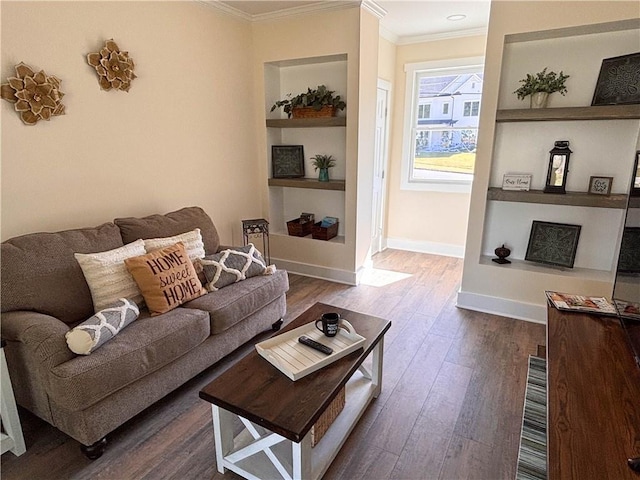 living room with dark hardwood / wood-style flooring, crown molding, and built in features