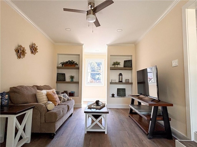 living room with crown molding, built in shelves, dark hardwood / wood-style floors, and ceiling fan