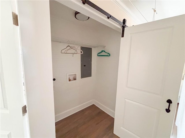 clothes washing area featuring washer hookup, hardwood / wood-style floors, electric panel, and a barn door