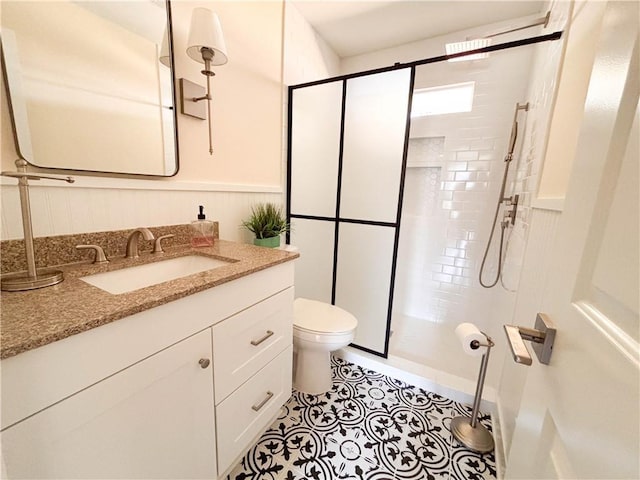 bathroom featuring vanity, an enclosed shower, tile patterned floors, and toilet