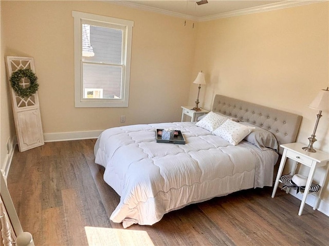 bedroom with ornamental molding and dark hardwood / wood-style flooring