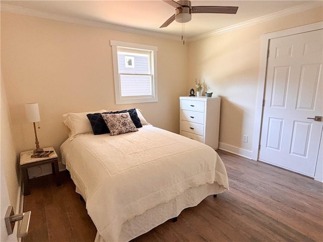 bedroom with ornamental molding, ceiling fan, and dark hardwood / wood-style flooring