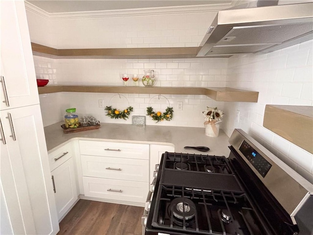 kitchen featuring stainless steel gas range, white cabinetry, tasteful backsplash, dark hardwood / wood-style flooring, and wall chimney exhaust hood