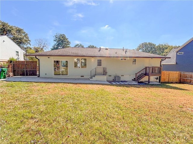 rear view of property featuring a patio, a yard, and cooling unit