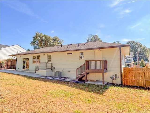 back of house featuring a yard, a patio, and central air condition unit