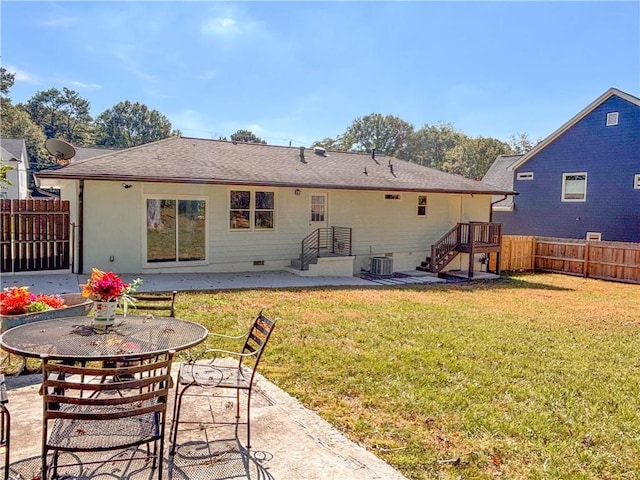 back of property with a yard, central AC, and a patio area