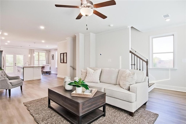 541 Fundao Ln, Lawrenceville, GA 30046 - living area featuring light wood finished floors, ceiling fan, recessed lighting, stairs, and ornamental molding