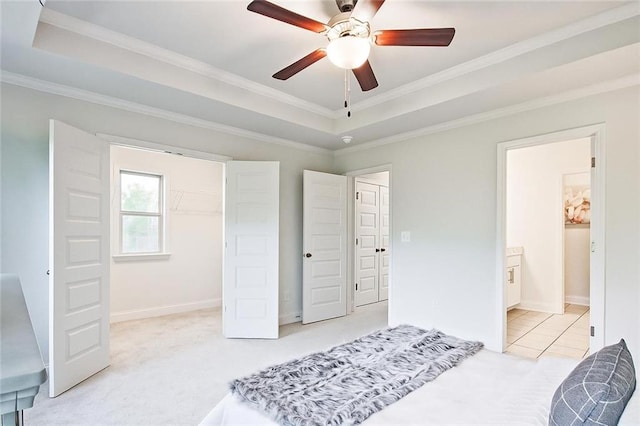 541 Fundao Ln, Lawrenceville, GA 30046 - bedroom featuring ornamental molding, carpet, a tray ceiling, a closet, and a walk in closet