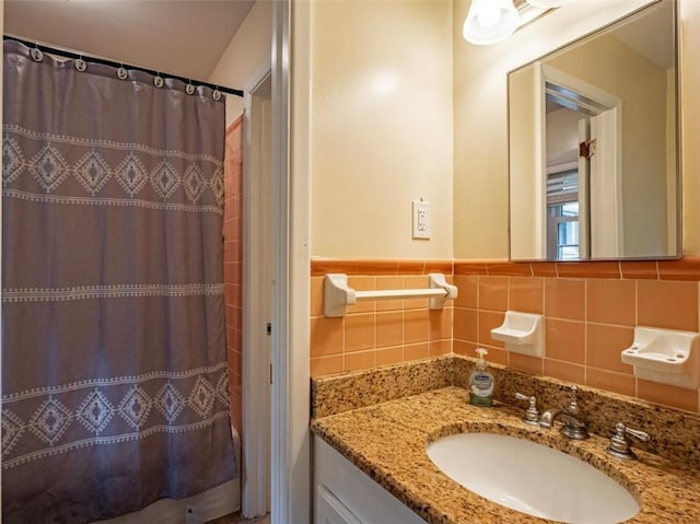 full bathroom featuring a shower with curtain, tile walls, and vanity