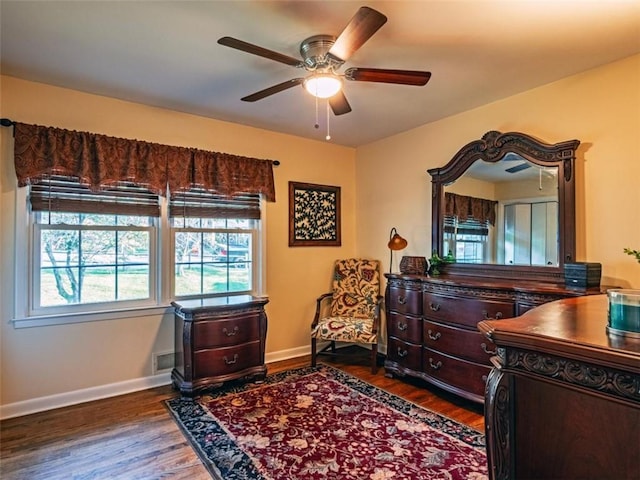 bedroom featuring dark wood-style floors, ceiling fan, visible vents, and baseboards