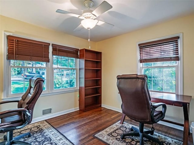 home office with baseboards, wood finished floors, visible vents, and a ceiling fan