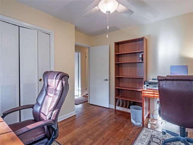 home office featuring baseboards, a ceiling fan, and wood finished floors