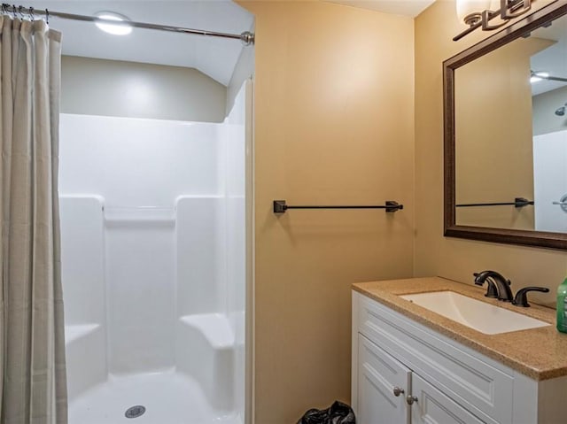 bathroom with curtained shower and vanity