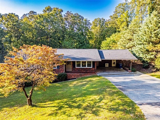 ranch-style home with a porch, brick siding, driveway, a carport, and a front lawn