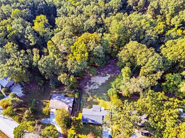 bird's eye view with a wooded view