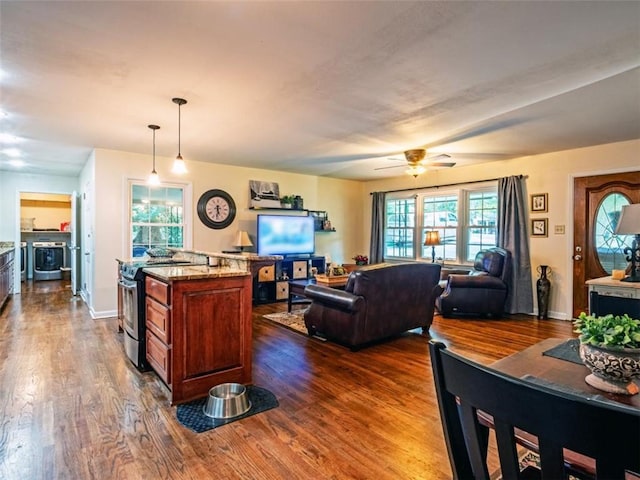 living room featuring dark wood-style flooring and baseboards