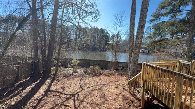 view of yard with a deck with water view