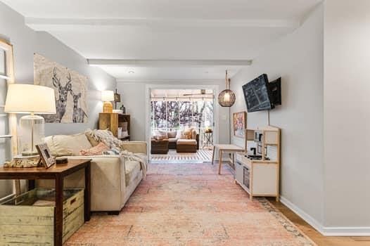 living room featuring beam ceiling