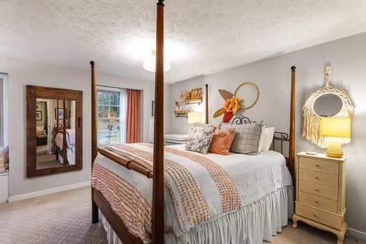 carpeted bedroom featuring a textured ceiling