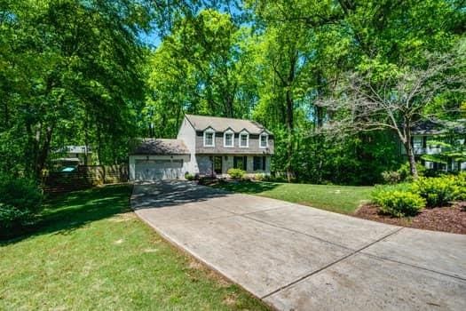 view of front of property with a garage and a front lawn