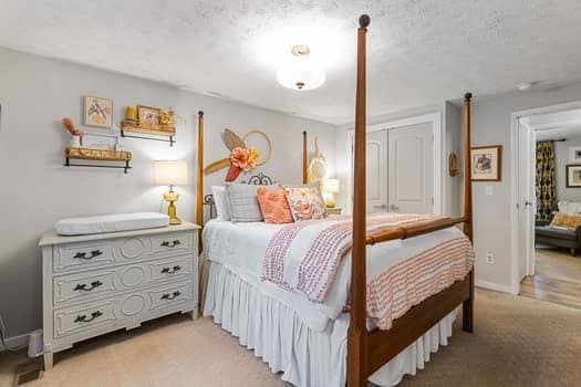 bedroom with light carpet, a closet, and a textured ceiling