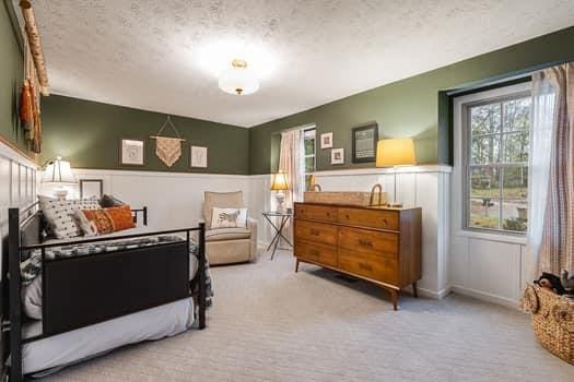 carpeted bedroom featuring a textured ceiling