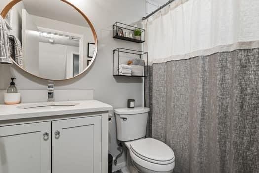 bathroom featuring vanity and toilet