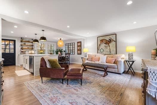 living room featuring beam ceiling and light wood-type flooring